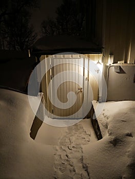 Approaching basemant house doors with full of snow - lovely appartment in Tromso