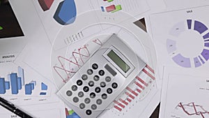 Approaching business background, focus on the calculator. Top view.