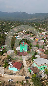 Approaching the charming village of Sabanillas Church: Vertical Drone Video