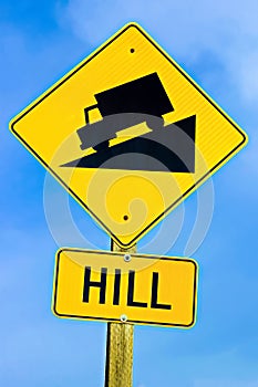 Approaching hill sign along highway