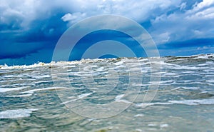 Approaching huge wave in the blue cold sea or ocean. Tsunami, storm hurricane