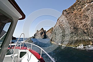 Approaching rocks of Scandola peninsula by boat