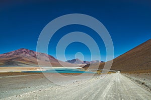 Approaching the Siloli salt flats on a dirt road photo