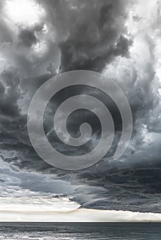 Approaching storm cloud with rain over the sea