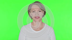 Approval by Old Woman, Shaking Head on Green Background