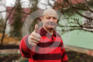 Approval of work, thumb up. The man in the village
