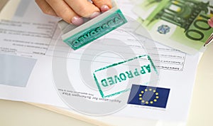 Approved EU visa application and cash euro banknotes