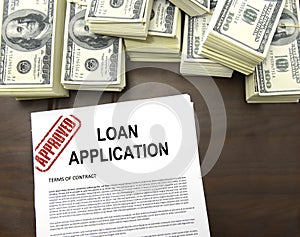 Approved loan application form and dollar bills photo