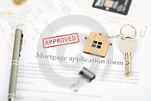 Approved mortgage loan agreement application with house shaped k