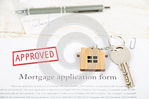 Approved mortgage loan agreement application with house shaped k