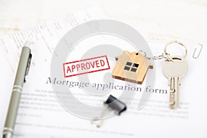 Approved mortgage loan agreement application with house shaped k