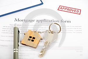 Approved mortgage loan agreement application with house shaped k
