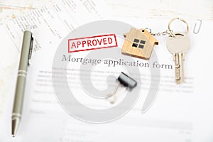 Approved mortgage loan agreement application with house shaped k