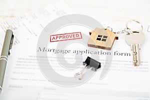 Approved mortgage loan agreement application with house shaped k