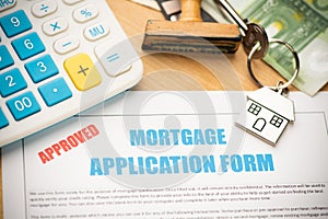 Approved mortgage loan agreement application with house shaped keyring