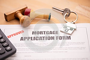 Approved mortgage loan agreement application with house shaped keyring