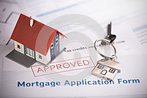 An approved Mortgage loan application form with house key and rubber stamp