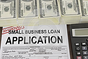 Approved small business loan application form and money photo