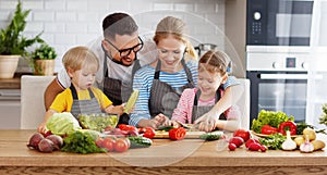 Appy family with child preparing vegetable salad