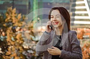 Ðappy woman talking on and laughing on the mobile phone