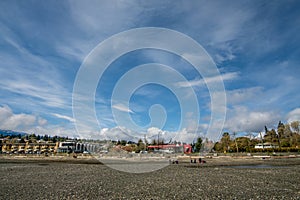 Apr 18, 2023 - Nanaimo, Canada: School children on Departure Bay Beach at low tide on a sunny day. View of the