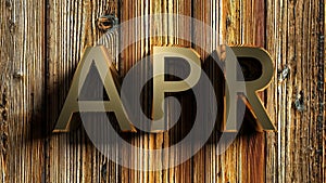 APR brass write on raw wooden background - 3D rendering