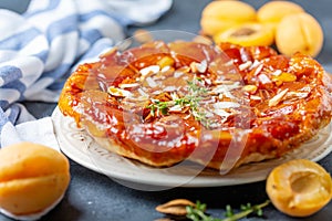 Apricot and almond tarte tatin on a white plate