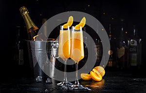 Apricot Bellini alcoholic cocktail drink with prosecco, cava, or sparkling wine with apricot puree, syrup and ice, dark bar