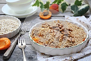 Apricot crumble from oatmeal, walnuts dressing for healthy breakfast