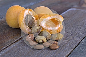 Apricot fruit cut open with pips and kernels in the foreground. photo