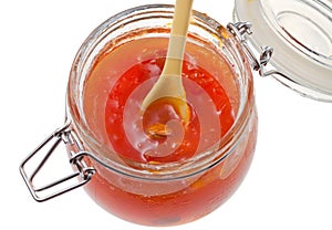 Apricot jam in glass jar close up photo