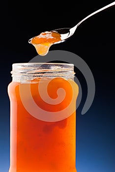 Apricot jam and tea spoon