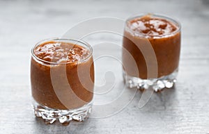 Apricot jam in two glass jars on the table