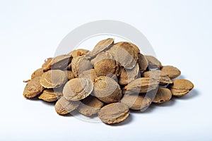 Apricot kernels on a white background.