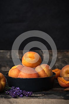 Apricots in a bowl on a wooden table