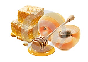 Apricots, honeycomb and honey dipper isolated on white background