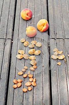 Apricots and pits on a wooden table