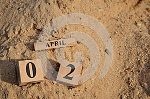 April 02, Number cube with Sand background.