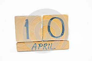 april 10th. Day 10 of month, handmade wood calendar isolated on white background. spring month, day of the year concept
