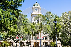 April 14, 2018 Sacramento / CA / USA - Exterior view of the City Hall rising behind the trees in Cezar E Chavez Plaza, built in