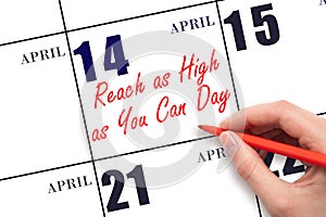 April 14. Hand writing text Reach as High as You Can Day on calendar date. Save the date.