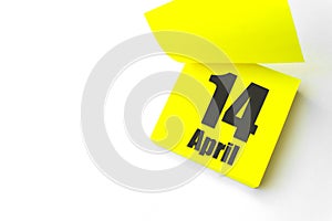 April 14th. Day 14 of month, Calendar date. Close-Up Blank Yellow paper reminder sticky note on White Background. Spring month,