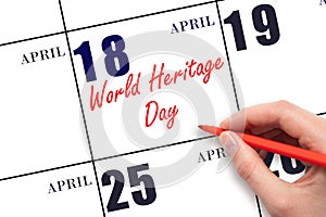 April 18. Hand writing text World Heritage Day on calendar date. Save the date.