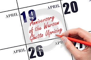 April 19. Hand writing text Anniversary of the Warsaw Ghetto Uprising on calendar date. Save the date.