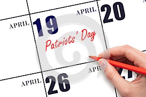 April 19. Hand writing text Patriots' Day on calendar date. Save the date.