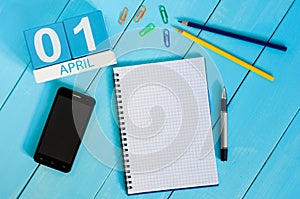 April 1st. Image of april 1 wooden color calendar on blue background. Empty space for text. All Fool`s Day