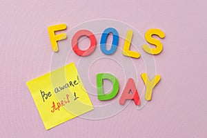 April 1st. Image of letter Fools day and festive decor on the purple background