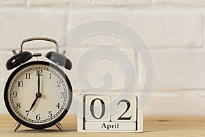 April 2 on a wooden white calendar. April 1 on a light background. Spring day. World Day of Laughter