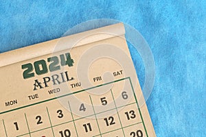 April 2024 calendar flat lay in blue background with copy space.