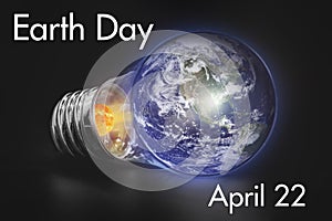 April 22, Earth Day, Concept - Save our planet, planet Earth in a light bulb on a black background